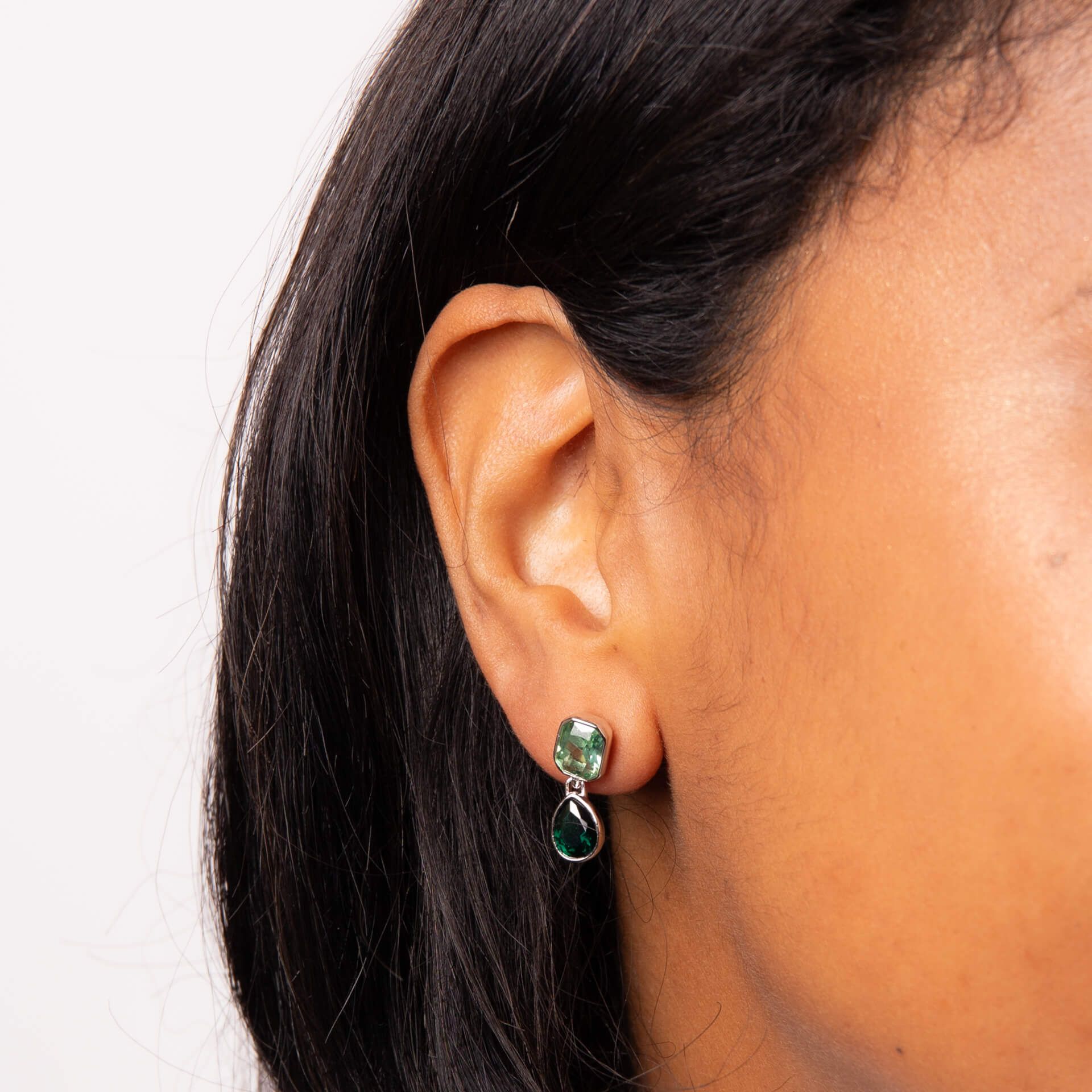 Green crystal octagon and teardrop earrings in silver.