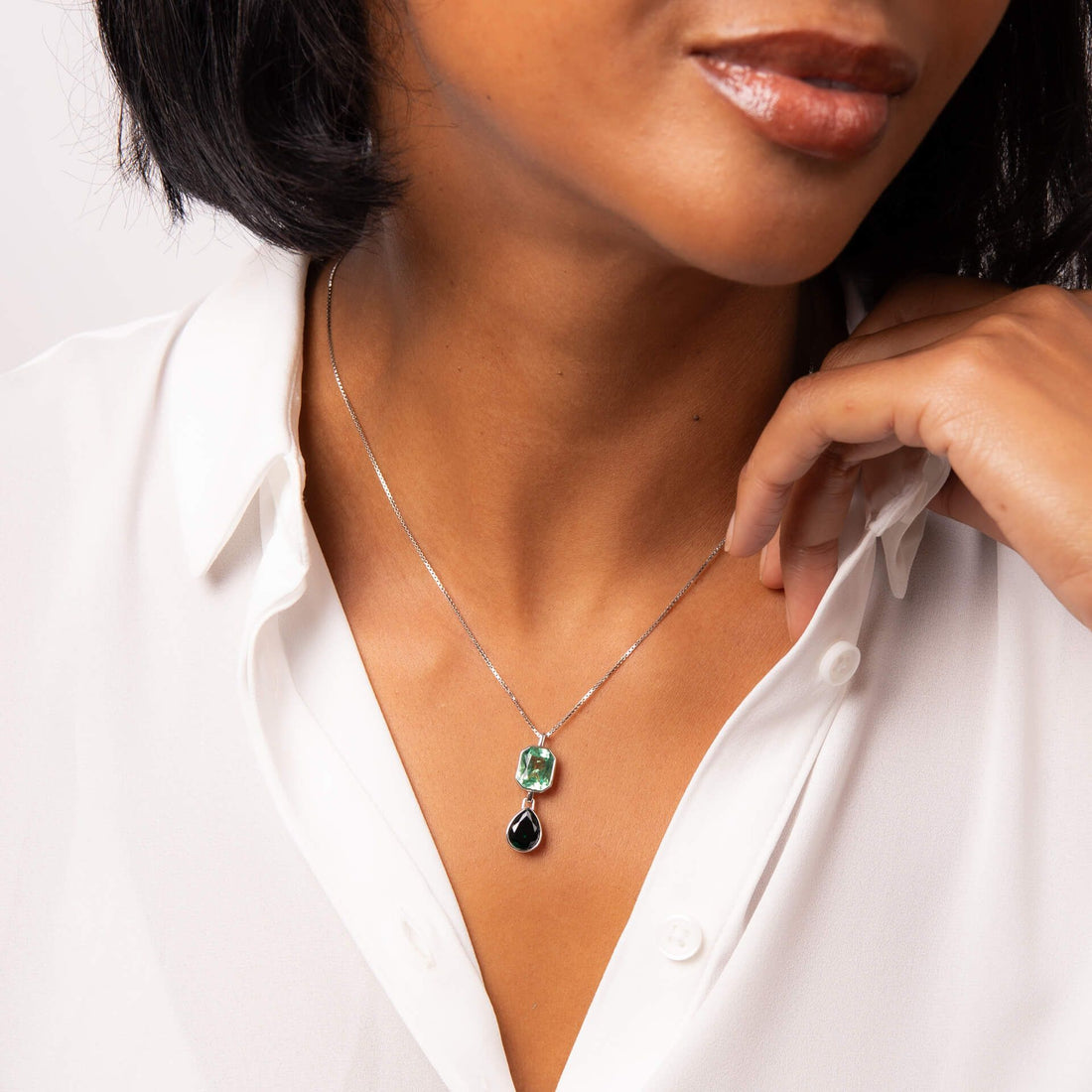 Green crystal octagon and teardrop shaped pendant and chain in silver.