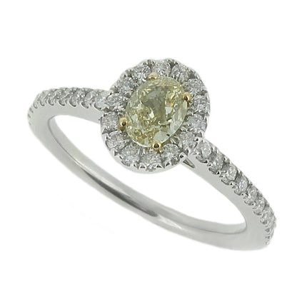 Oval yellow diamond and diamond halo cluster ring in platinum and 18ct gold